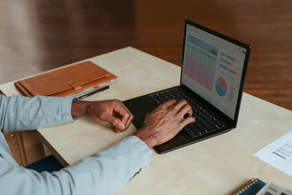 Person working on a laptop displaying business charts
